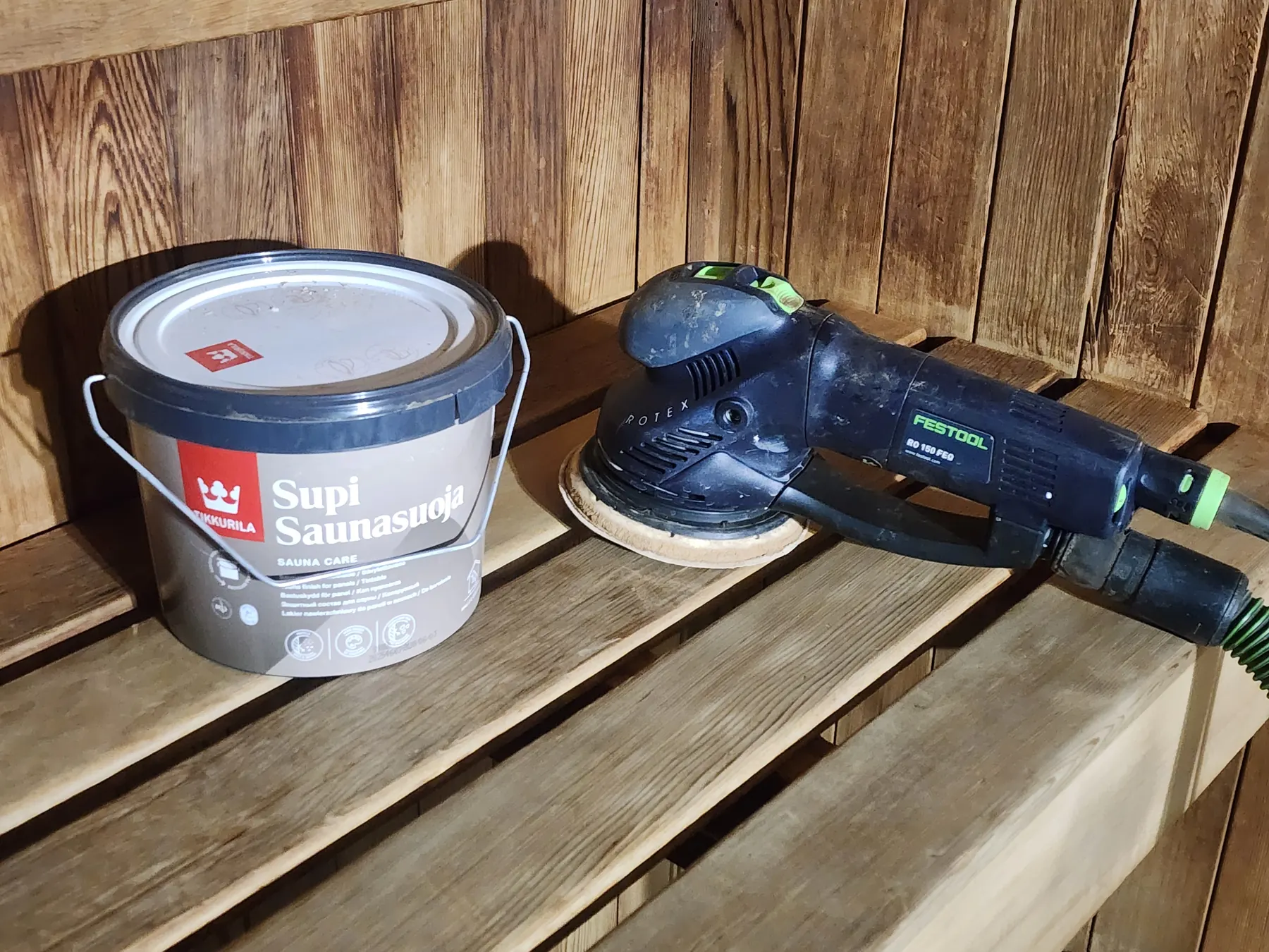 Supi Saunasuoja sauna wax tin beside the sander