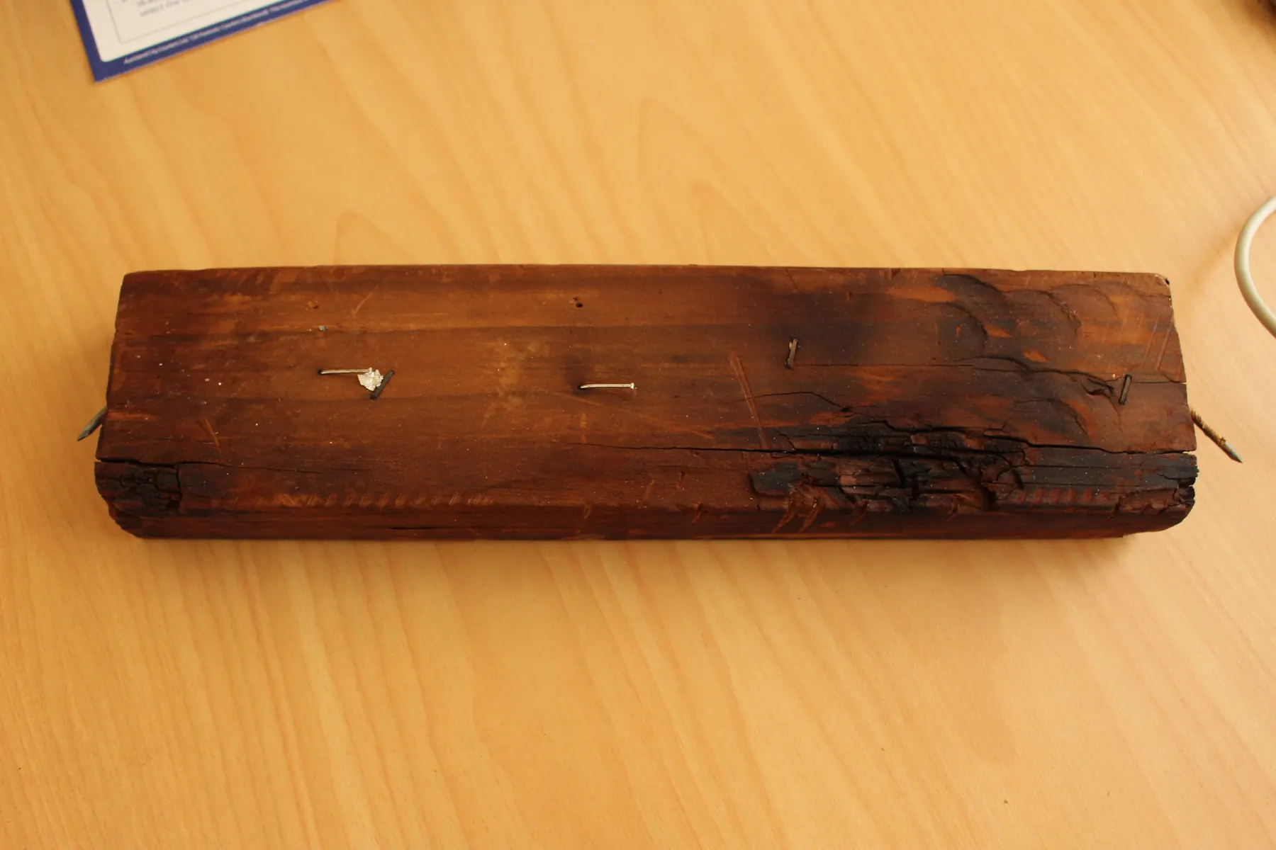 A piece of sauna framing timber baked dark brown by heat