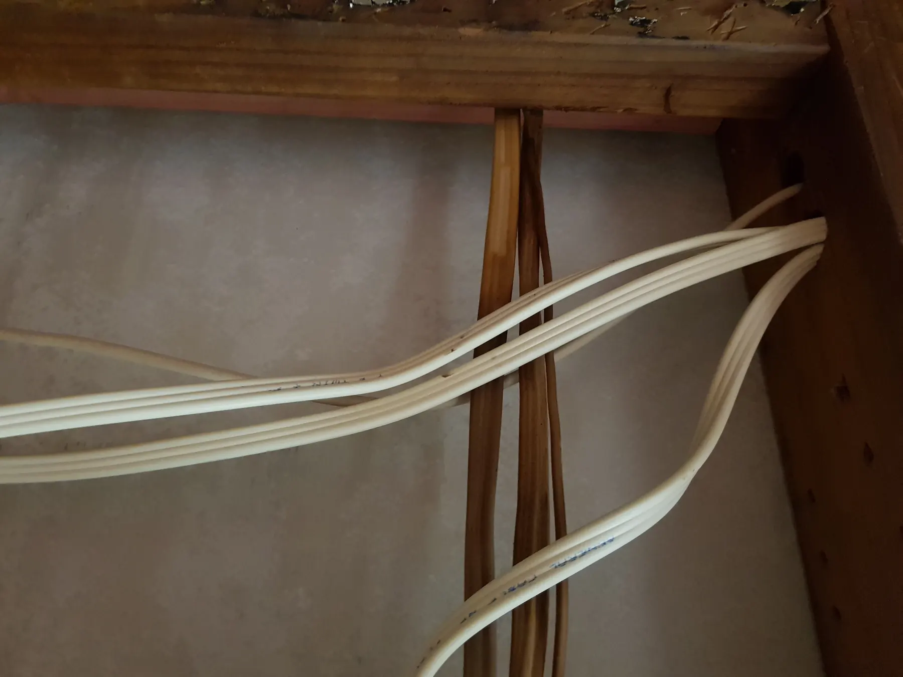 Standard cables running loose through the sauna wall cavity